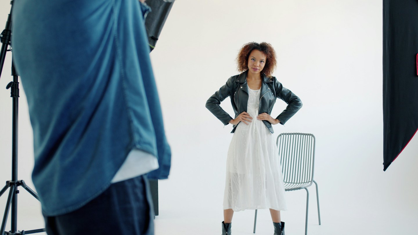 Photographer taking picture of model in studio.