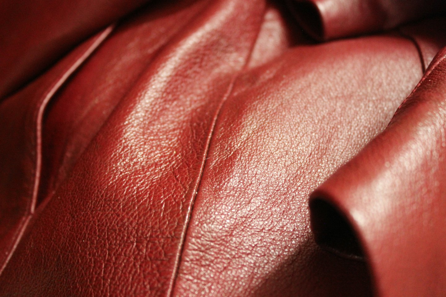 Dark red leather with visible texture and stitching.